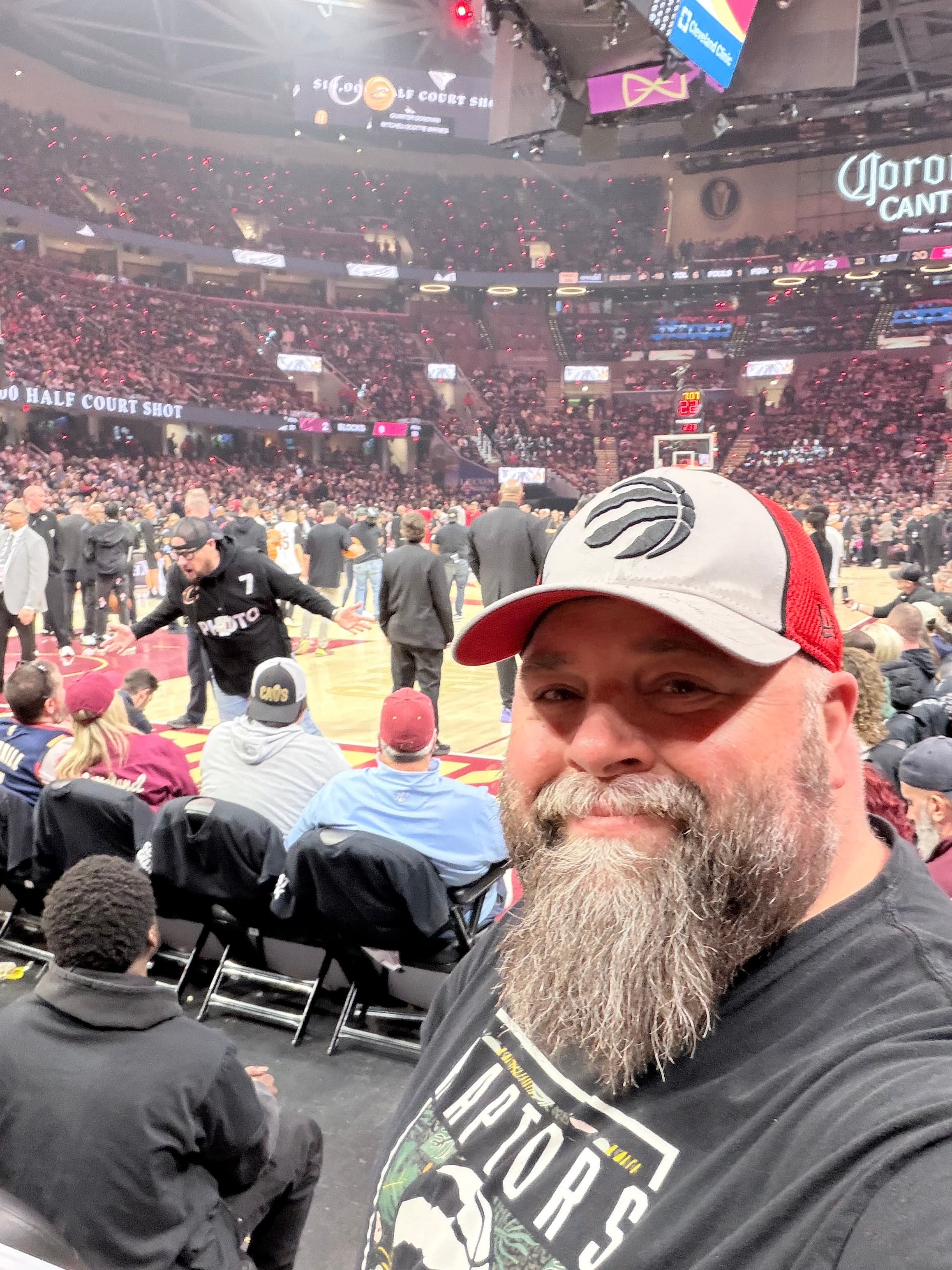 Nolin at Rocket Mortgage FieldHouse in Cleveland, wearing a Raptors cap